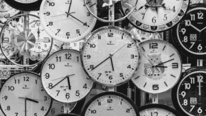 Black and white clocks showing different times representing different life timing and how each person moves through time at their own pace.